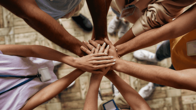 Volunteers at the Hartville Thrift Shoppe piling their hands together